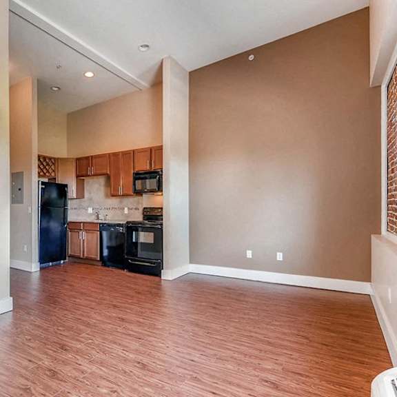 a kitchen with a refrigerator, microwave, and oven.