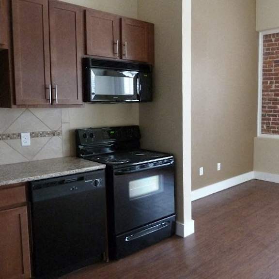 a kitchen with a black stove and oven.