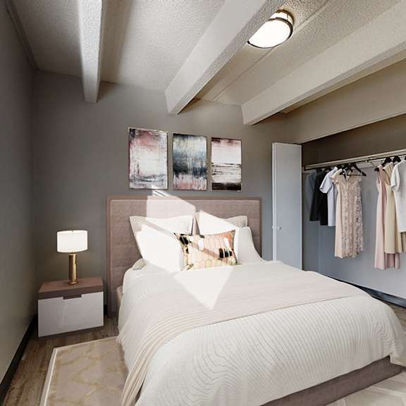 a bedroom with a large bed and a clothing rack.