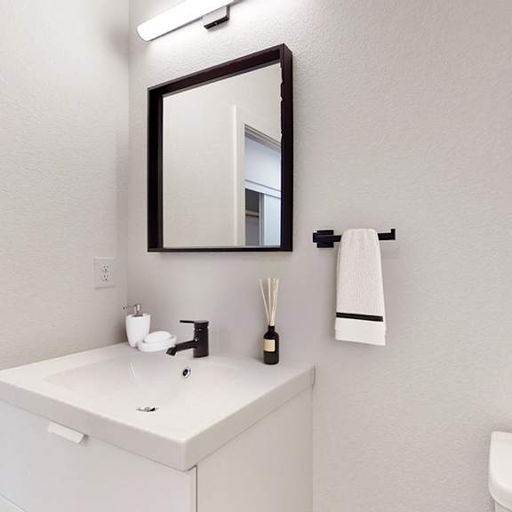 a bathroom with a white sink and a mirror.