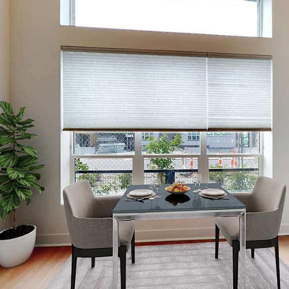 a dining room with a table set for two and a view of the city.