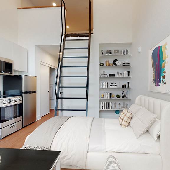a modern kitchen with a staircase leading to the upper floor.
