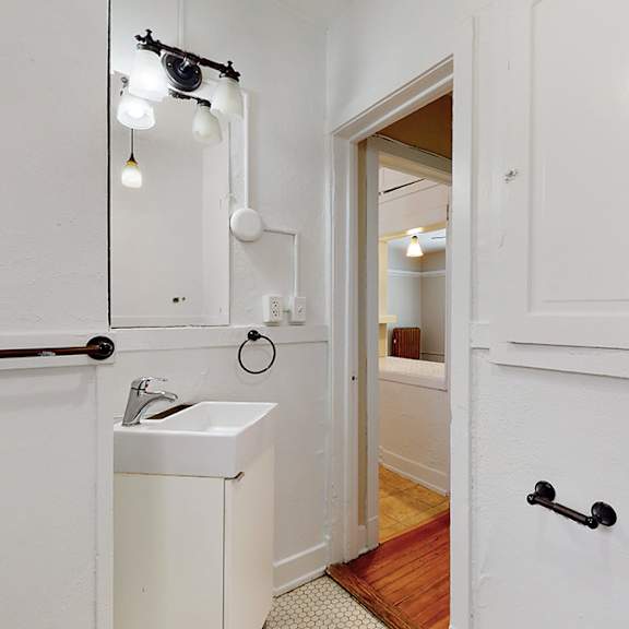 a bathroom with a sink and a mirror.