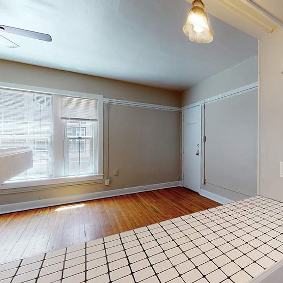 a room with a tiled floor and a ceiling fan.