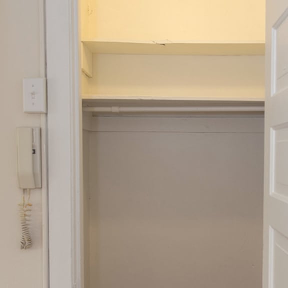 a white door with a phone on the wall.