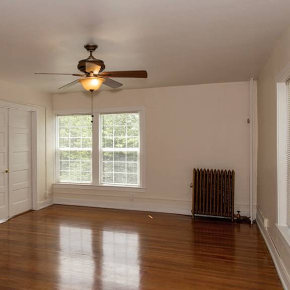 a room with a ceiling fan and a window.