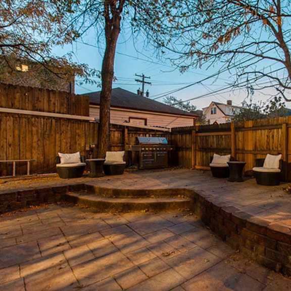a backyard with a patio and a fire pit.