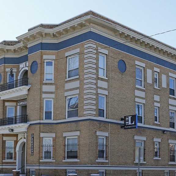 a large building with a balcony on the second floor.