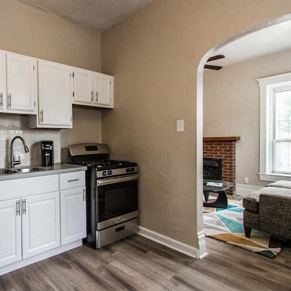 a kitchen with white cabinets and a stainless steel refrigerator.