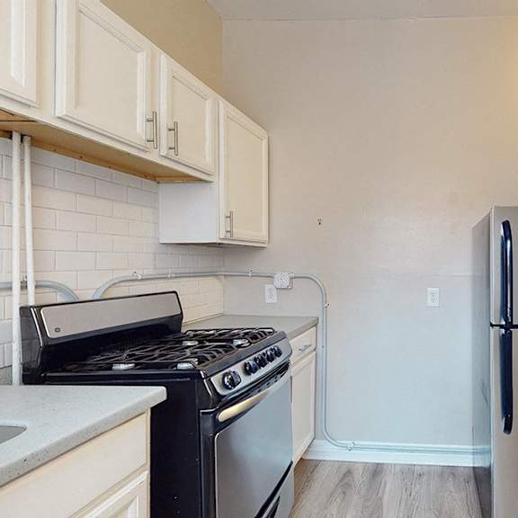 a kitchen with a stove, oven, and refrigerator.
