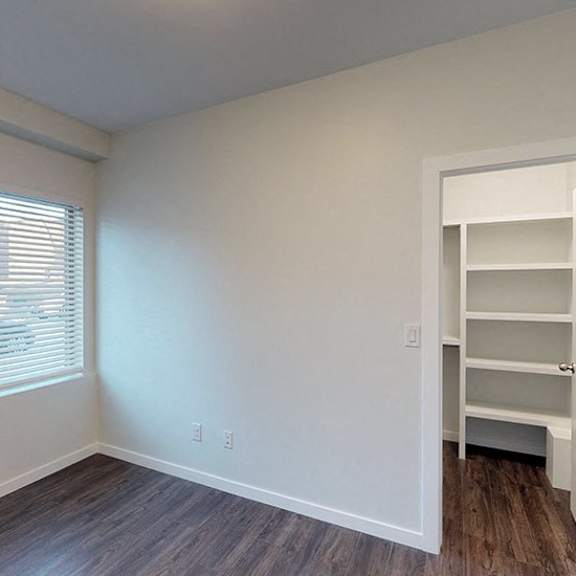 a room with a wooden floor and a white door.