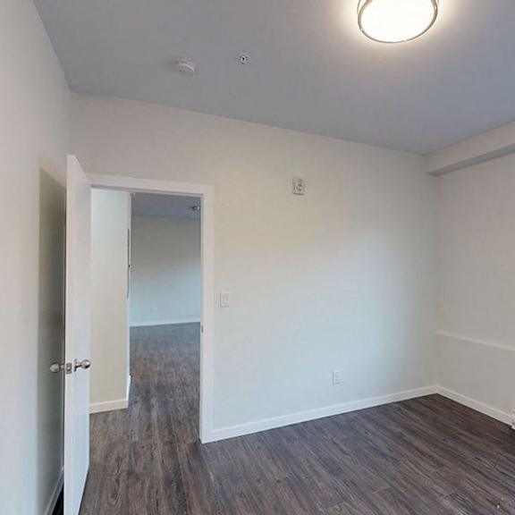 a room with a door and a window with blinds.