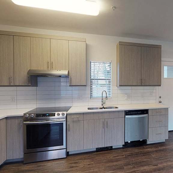 a kitchen with wooden cabinets and a stainless steel oven.