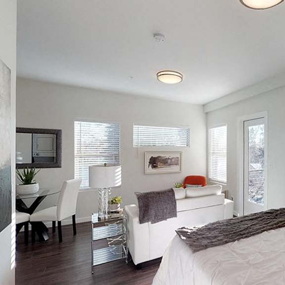 a bedroom with a large bed and a painting on the wall.