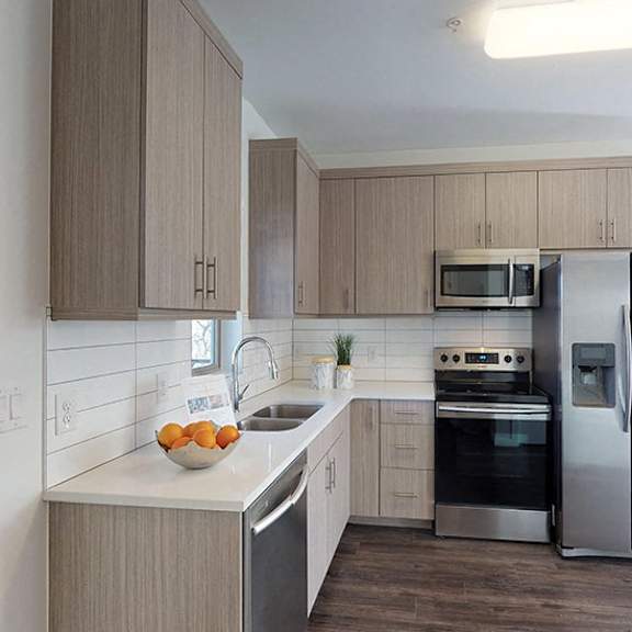 a modern kitchen with a stainless steel refrigerator and oven.