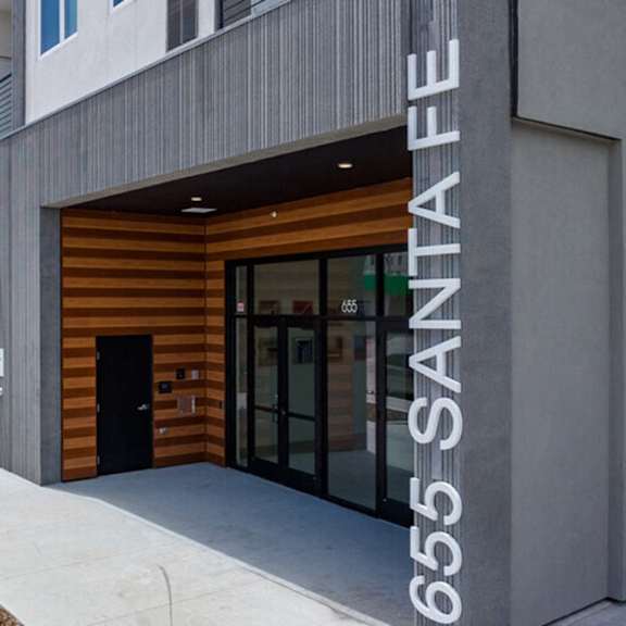 a modern building with a wooden door and the number 655 on the wall.