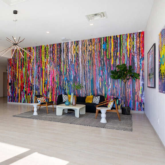 a room with a colorful wallpaper and a white sofa.