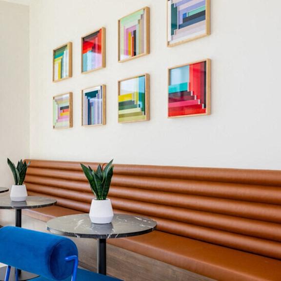 a room with a table and chairs and pictures on the wall.