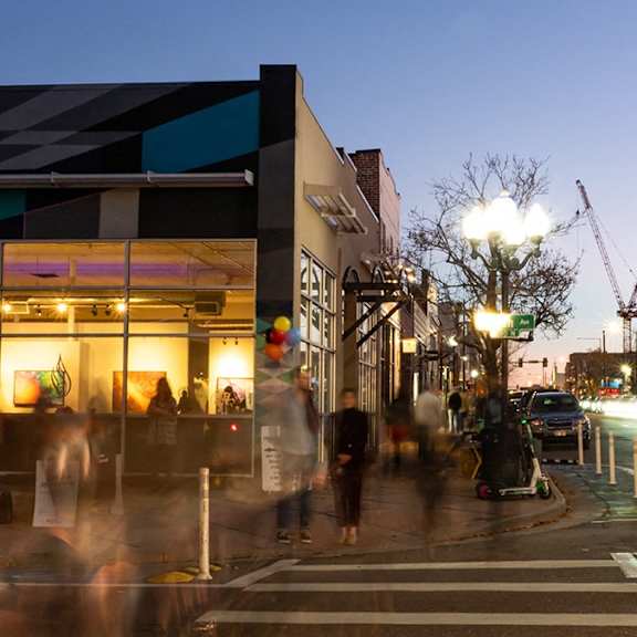 a busy street scene with a crosswalk and people walking.