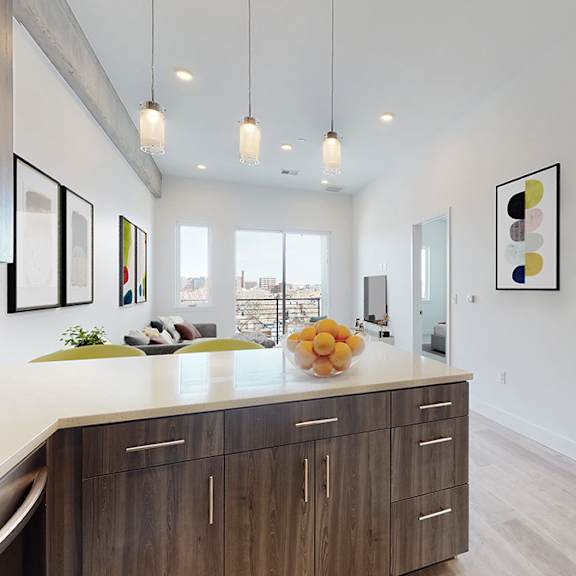 a modern kitchen with wooden cabinets and a white countertop.