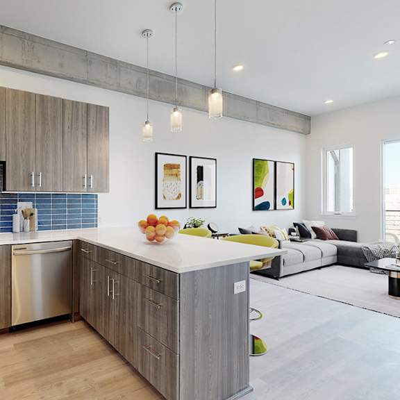 a modern kitchen with wooden cabinets and a blue backsplash.