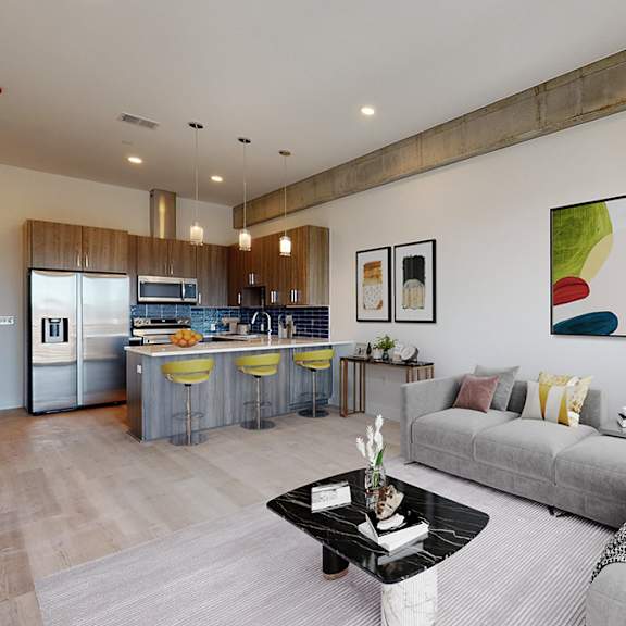 a modern living room with a grey sofa and a coffee table in the center.