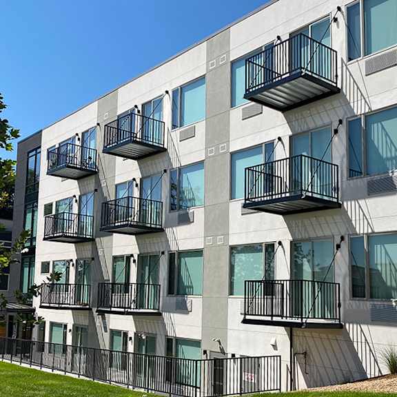 a modern building with balconies and windows.