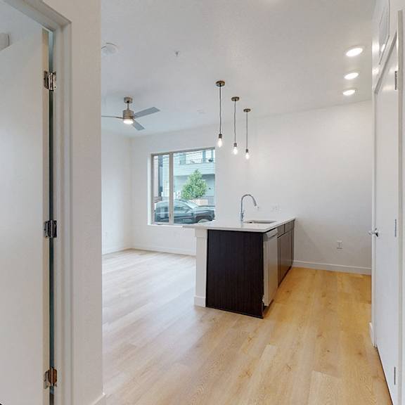 a room with a wooden floor and a black cabinet.