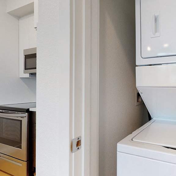 a white dishwasher is installed in a kitchen.