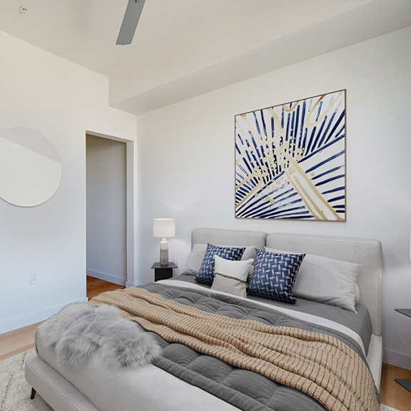 a bedroom with a bed, a nightstand, and a painting on the wall.