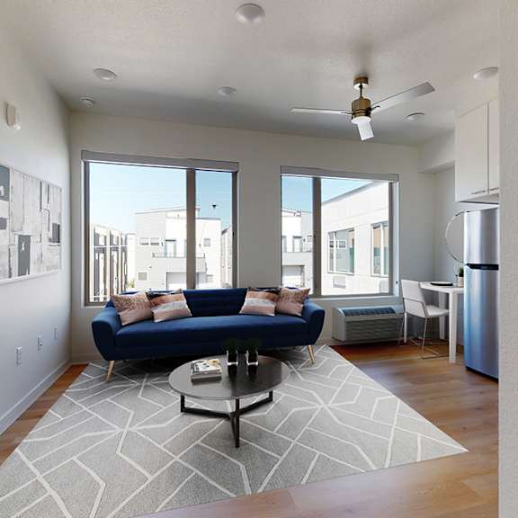 a living room with a blue couch and a coffee table.