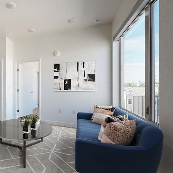 a living room with a blue couch and a coffee table.