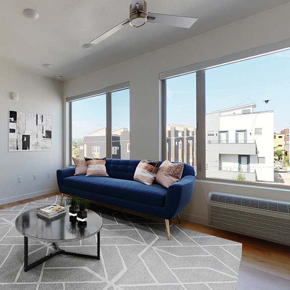 a living room with a blue couch and a coffee table.