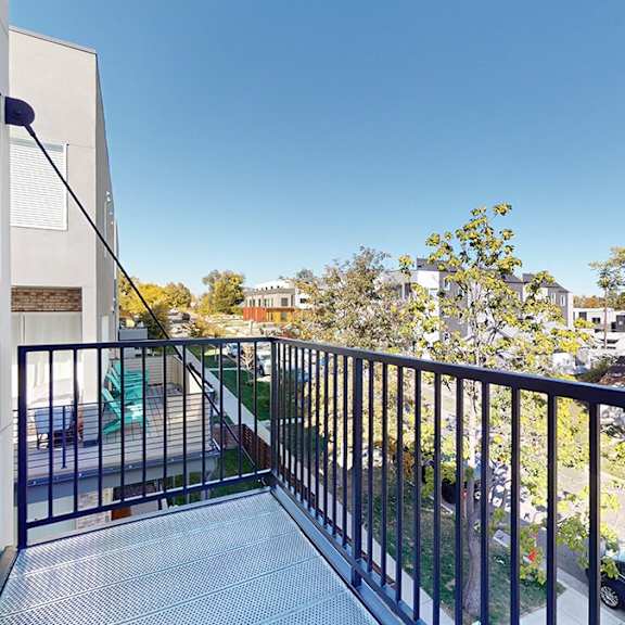 a balcony with a metal railing and a glass floor.