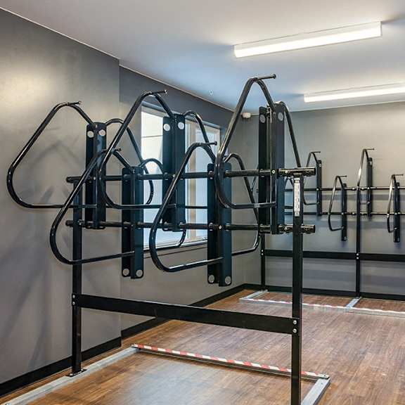 a gym with a row of exercise machines.