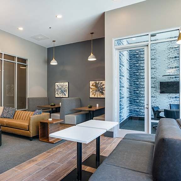 a modern living room with a flat screen tv mounted on the wall.