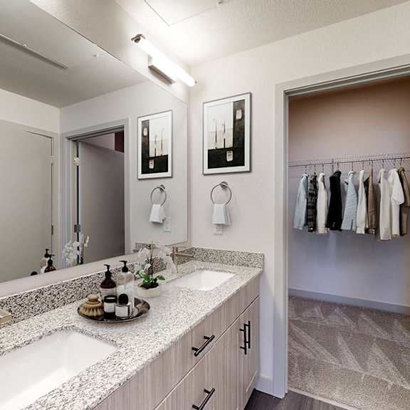 a bathroom with a sink, mirror, and a wall-mounted towel rack.