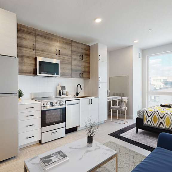 a modern kitchen with a stainless steel refrigerator and a wooden accent wall.