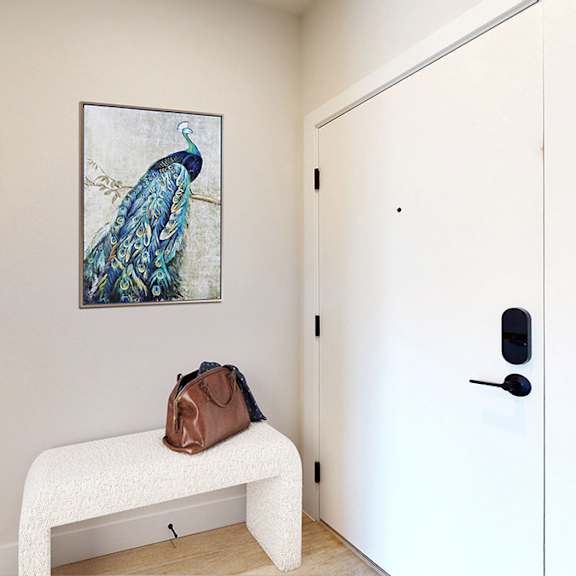 a painting of a bird hangs on a wall above a bench with a bag on it.