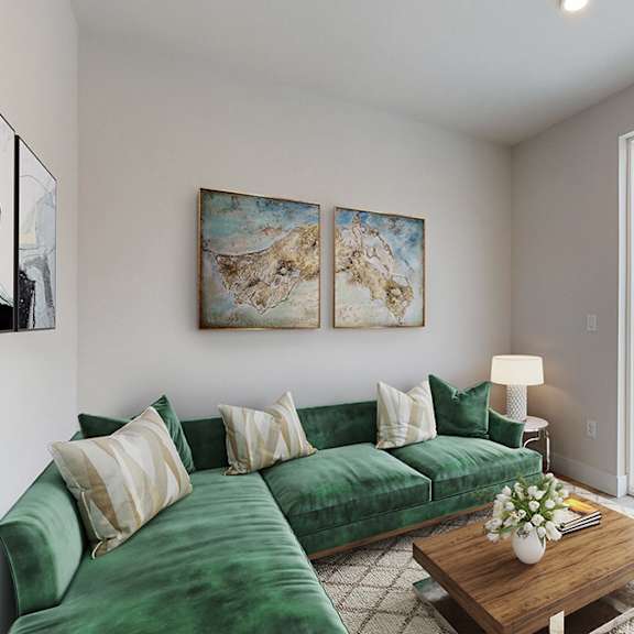 a living room with a green couch and a wooden coffee table.