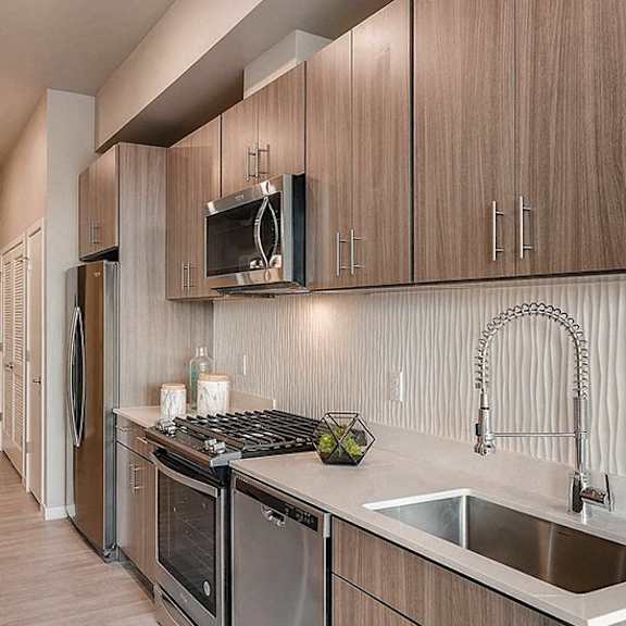 a kitchen with wooden cabinets and stainless steel appliances.