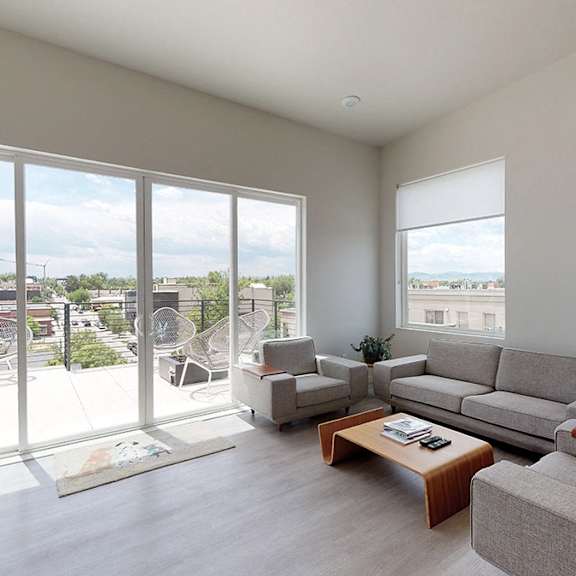 a living room with a grey couch and a coffee table.