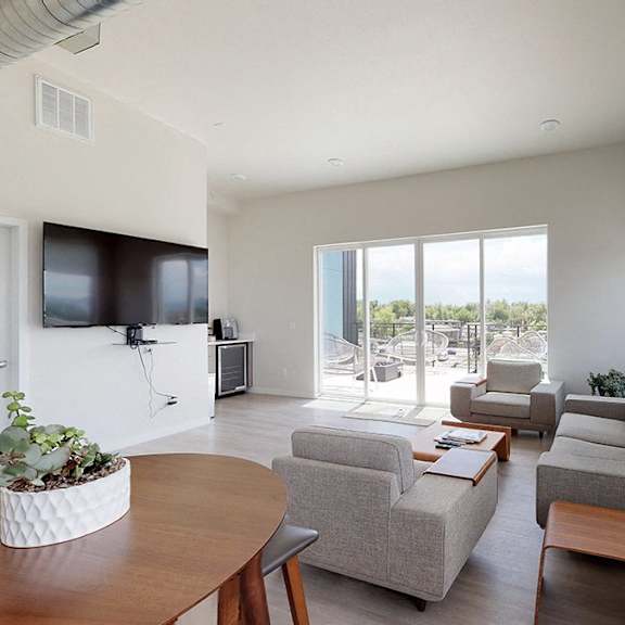 a living room with a grey couch and a wooden table.