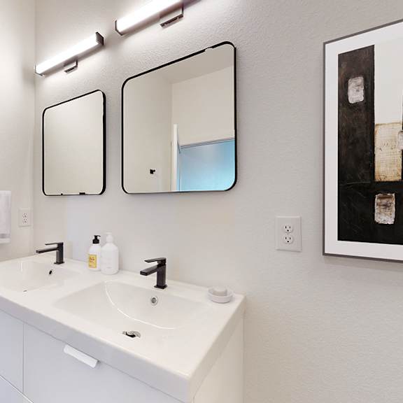 a bathroom with a white sink and a white cabinet.