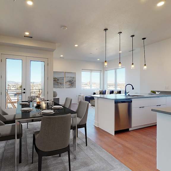 a modern kitchen with a dining table set for four.