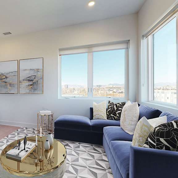 a living room with a blue couch and a television.