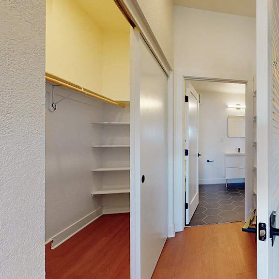 a white kitchen with a refrigerator, oven, and microwave.