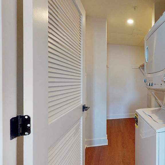 a white microwave oven is on top of a white dishwasher.