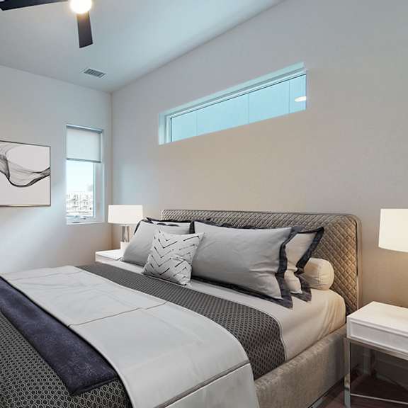 a bedroom with a large bed and a ceiling fan.