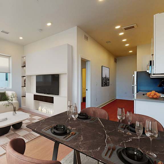 a modern living room with a black and white abstract painting on the wall.